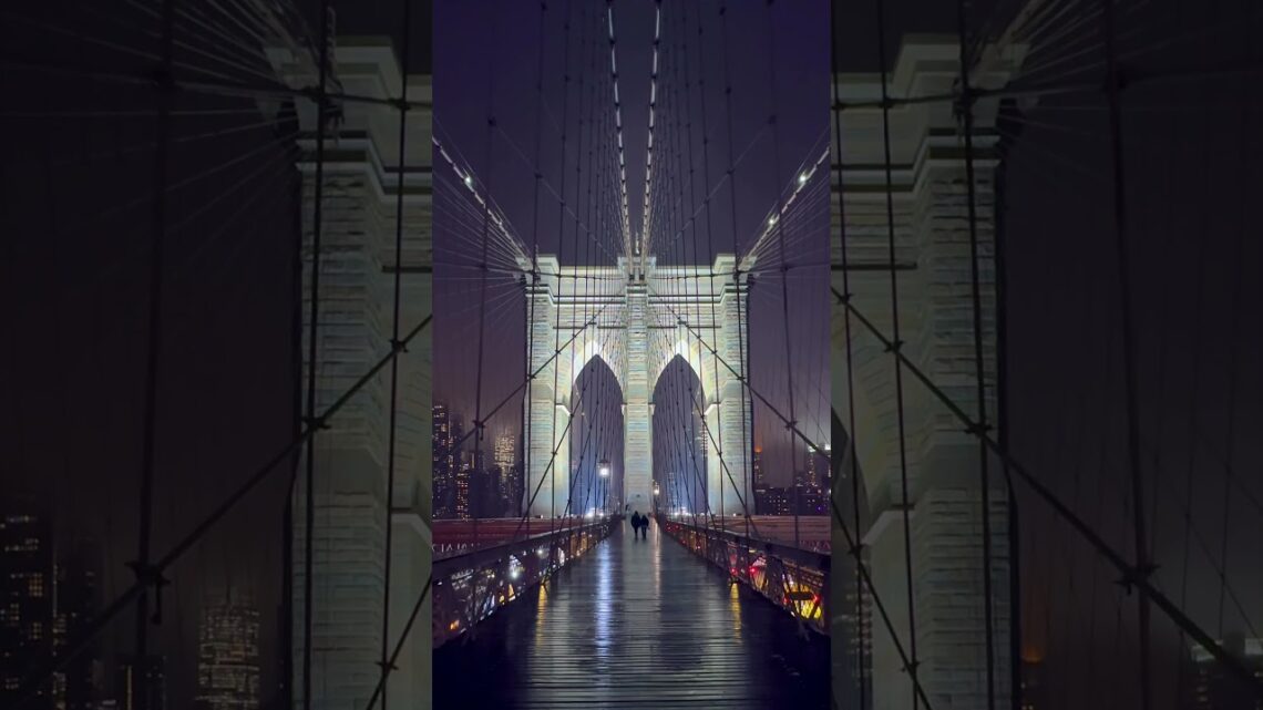 Crossing The Iconic Brooklyn Bridge In New York City