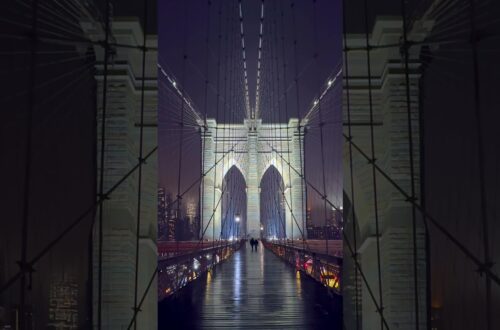 Crossing The Iconic Brooklyn Bridge In New York City